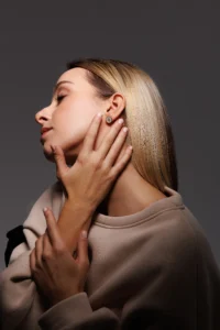 Modella che indossa l'orecchino Round Dalia Bianco, visibile al lobo.